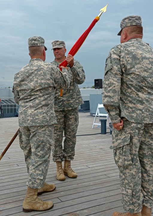 Col. Kevin Landers, center, the incoming Wilmington District commander, receives the Army Corps of Engineers flag from Brig. Gen. Todd Semonite, the Corps’ deputy commanding general, as the outgoing commander, Col. Steve Baker, stands at attention. Photo: Army Corps of Engineers