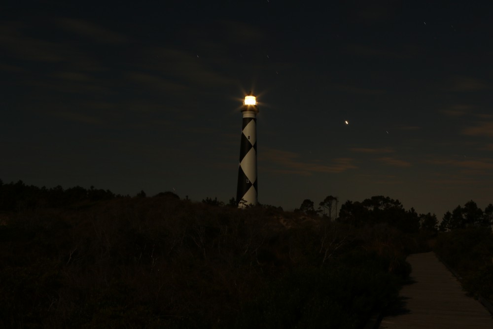 Walking back to the beach, I paused to look back at the lighthouse. I imagined the keeper slowly walking up the dark spiral stairwell then emerging onto the catwalk into the brightness of the full moon.