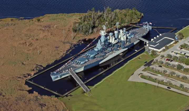 This is an artist's depiction of the cofferdam that will encircle the ship. Water will be pumped out will the work on the hull goes on. When completed, water will be allowed back in and the dam will become a walkway. Photo: USS North Carolina