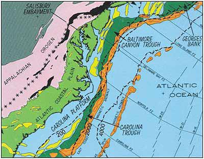 Geologic framework of the mid-Atlantic continental margin shows the following relevant features: Appalachian and Piedmont Provinces (pink), Coastal Plain Province (light green), exposed rift basins on land (black), rift basins buried beneath marine sediments (yellow), and deep-water offshore basins (dark green and western orange strip). The black dashed lines, from left to right, represent the -200 meter (-667 foot), -2,000 meter (-6,667 foot), and -4,000 meter (-13,333 foot) contour below mean sea level. Graphic: Report Of The Governor’s Scientific Advisory Panel On Offshore Energy