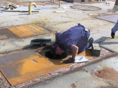 A Coast Guardsman checks an abandoned barge. Photo: Coast Guard