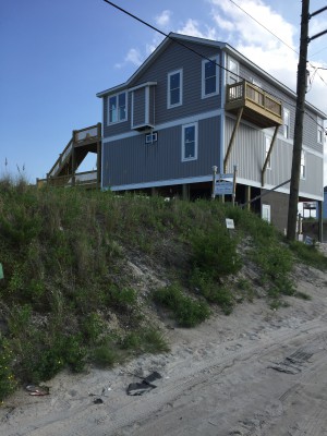 This newly constructed home sits on a lot amid an oceanfront stretch of properties at the southern end of Topsail Beach. The homeowners received permits to build before the town board in June amended Topsail Beach's dune permit ordinance, which prohibits the removal of more than one cubic yard of sand from the dune system. Photo: Trista Talton