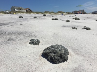 In addition to smaller rocks, people walking the beach have to watch out for larger rocks such as these scattered on shore. Photo: Talton