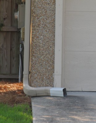 Turning a downspout from a paved surface like a driveway to a lawn or other vegetated area is a simple way to reduce the flow of stormwater runoff. Photo: N.C. Coastal Federation