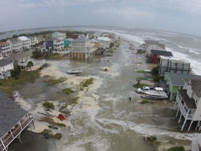 High tide Sunday brought the ocean over the dunes in Ocean Isle. Photo: Christopher Surigao 