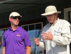 Greg “Rudi” Rudolph, left, and Charles “Pete” Peterson talk about the effects of rising seas during a 2015 event in Onslow County. Photo: Brad Rich, Tideland News