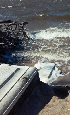 High water and waves have seriously eroded the cemetery and partially exposed some tombs. Photo: Island Free Press