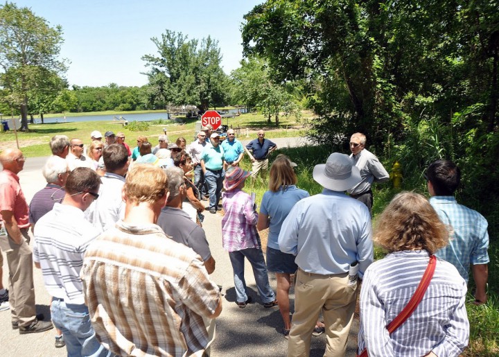 Civil engineer Larry Sneeder describes how swales function to the group that recently toured Oak Island. Photo: Todd Miller