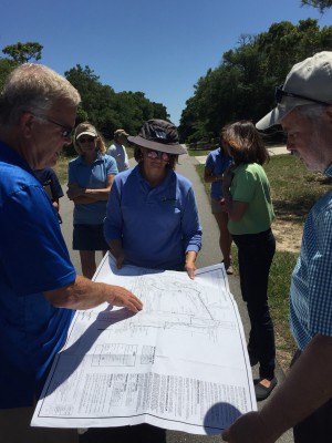 Civil engineer Brad Sedgwick, left, explains a stormwater system to Tracy Skrabal and Todd Miller of the North Carolina Coastal Federation during the tour of Oak Island. Photo: Ashita Gona