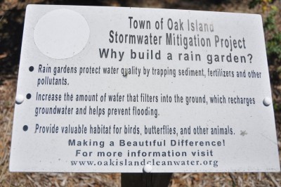 Signs describe the stormwater mitigation projects at sites, including this rain garden, on Oak Island. Photo: Todd Miller