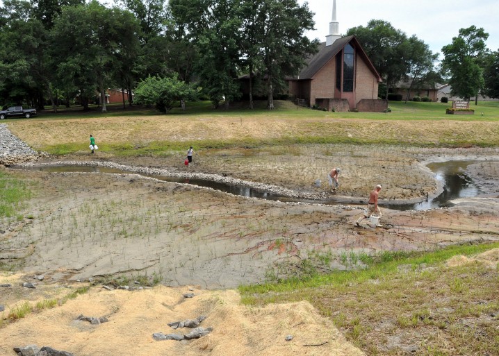 EWNC members and federation staff put down about 80 feet of oyster shells along the tidal creek to draw live oysters to the area. Photo by Todd Miller.