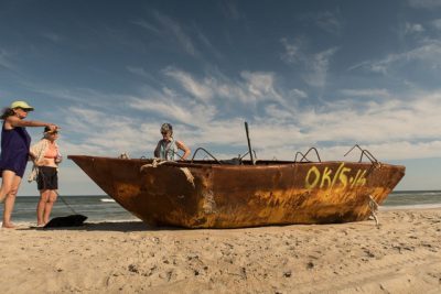 Jennifer Miller, left, Pat Arnow, center, and Catharine Callaway came upon the rusted boat with the strange marking while sailing along Core Banks. Photo: Joanie Alexander