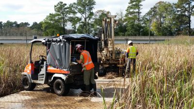 Multistate trust contractors use swamp mats to move equipment into place to take soil samples in the marsh. Photo: Greenfield Environmental Multistate Trust