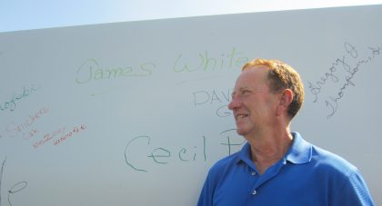 After signing his names to the first blade that will go up, farmer James White said he was excited that Amazon Wind Farm, after numerous fits and starts, is finally taking shape. Photo: Catherine Kozak