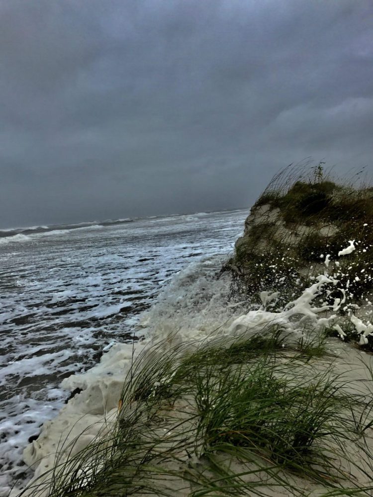 Surf washes over the dunes at Emerald Isle on Saturday. Photo: Sam Bland
