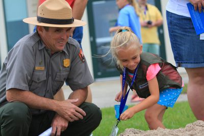 Pat Kenney celebrates the 50th anniversary of Cape Lookout National Seashore with a junior ranger. Photo: Britt Brown, National Park Service 