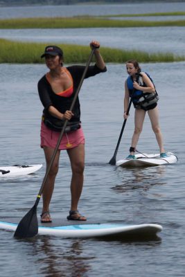 April Clark leads a stand-up paddleboard class. Photo: Jennifer Miller Pearce