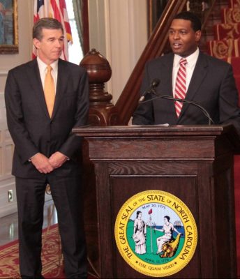 Gov. Roy Cooper, left, introduces Michael Regan, his pick to lead the Department of Environmental Quality. Photo: Kirk Ross