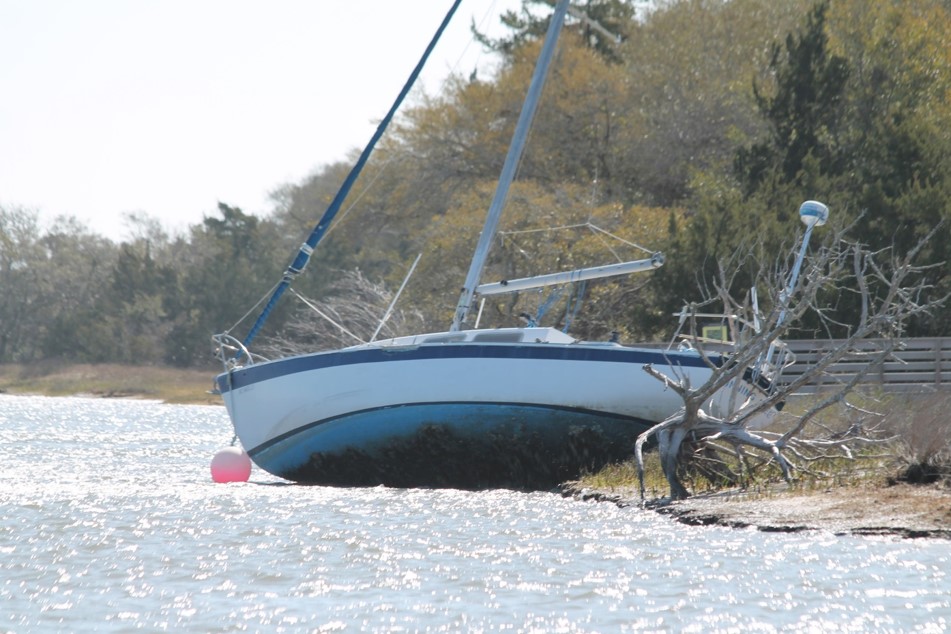 Carteret County Board of Commissioners unanimously adopted Monday night an ordinance giving the county authority to manage abandoned and derelict vessels in its waters. The same night, New Hanover County commissioners approved its first reading of an abandoned vessel ordinance, authorizing the Sheriff's Office to tackle abandoned vessels in county waters. The second reading is set for the June 17 meeting, according to the county. The Carteret County ordinance states that abandoned and derelict vessels are “expressly prohibited in navigable waters within the jurisdiction of unincorporated Carteret County” with the exception of archaeological remains including shipwrecks, cargo and anything else in place more than 10 years. An abandoned vessel is considered one that is moored for more than a month without permission of the property owner, is unmanned and slipping anchor, and a derelict vessel is in danger of sinking or has sunk, or is an immediate danger. A state statute gives counties the authority to remove and dispose of any abandoned or derelict vessels. Sharon Griffin, Carteret interim county attorney, said during the meeting that the ordinance is not aimed at the vast majority of boat owners who take care of their boats, like owners who have registered their boats, had safety checks, and made sure the vessel is properly anchored or secured to a dock. “These are those vessels that we occasionally see that basically have sunk or are in terrible condition or have been completely abandoned and are threatening somebody else's property, or boat or dock,” Griffin said. “We wanted to give our law enforcement an opportunity to be able to enforce that. They didn't really have a good means of doing that.” Griffin said that much of the language in the county statute mirrors the state statute, including that if “the vessel that's moored, anchored or otherwise located for more than 30 consecutive days in any 180 consecutive day period without the permission of the dock owner, marina owner, or property owner, that's directly out of the statute.” Other examples she noted of an abandoned vessel is one that is slipping anchor and causing a significant danger to other people's property or boat. “A derelict vessel is one of those that we occasionally see out in our coastal waters that has just been abandoned by someone and is resting on the bottom,” she said. The statute also includes those who do not have current state registrations, and those being used as living quarters but don't have any method of getting rid of waste and are causing an environmental problem with the removal of the abandoned and derelict vessels. “There's also an opportunity for civil penalties, and that's just because there are occasions when someone really just will not move their boat, and we need to give law enforcement the opportunity to enforce that,” she said. County Commissioner Ed Wheatly asked where the money would come from to take care of the boats. Griffin answered that they’ve spoken with several different agencies and is aware of grant money for vessel removal. “And if you'll notice also in the ordinance, the first paragraph specifically states this is not obligating the county, the Board of Commissioners to appropriate funds for this,” she said. “So we're not trying to obligate our Board of Commissioners to go fundraising and to find the money for this. We're hopeful that we'll be able to start this through some grant funding. Perhaps some law enforcement programs.” Chairman Jimmy Farrington added that the North Carolina Coastal Federation had reached out to the county to help with removal. Farrington continued that the commission has given this a lot of thought, this was brought it up almost a year ago. “We really don't want to get in the weeds with this,” he said, or get on personal property but these are the boats that you see sitting out there that sunk, that could cause very serious damage. “We're not getting into the boat control business, we’re just trying to clean up what's out there,” Farrington said. “Many of these towns have done a great job of trying to clean up and that type of thing because that's a kickback for it. But I think we're after the obvious.