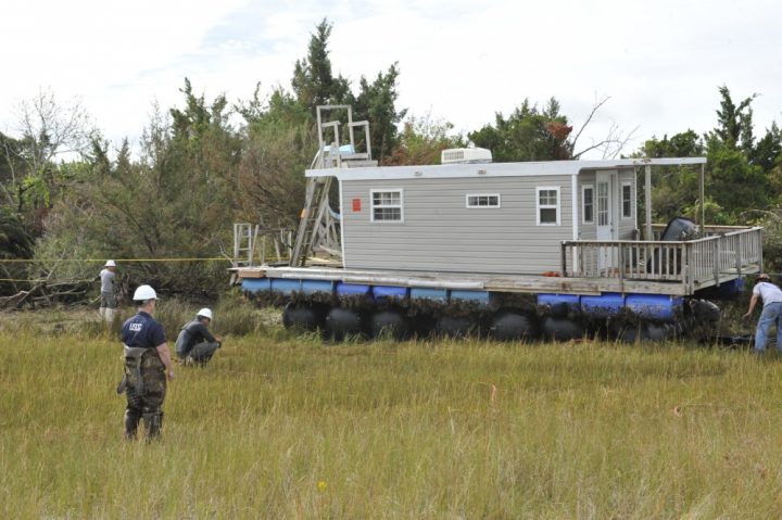 Coast Guard Petty Officer 3rd Class Seth Grayson oversees the Oct. 27 removal of a houseboat that Hurricane Florence washed ashore at the Rachel Carson Reserve. Photo: Petty Officer 3rd Class Brandon Hillard