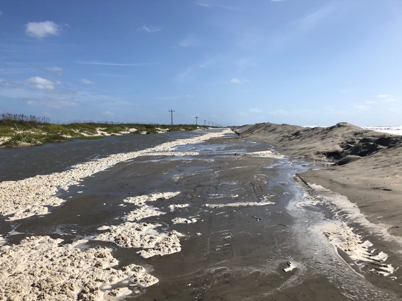 A section of N.C. 12 on Ocracoke Island between the Pony Pens and the ferry terminal is shown with dune breach and ocean overwash. Photo: NCDOT 