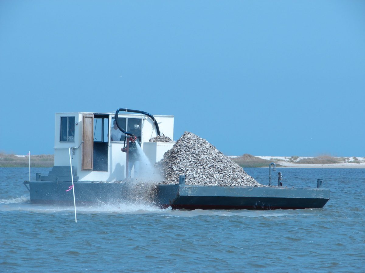 Crews work to deploy oyster shell. Photo: North Carolina Coastal Federation