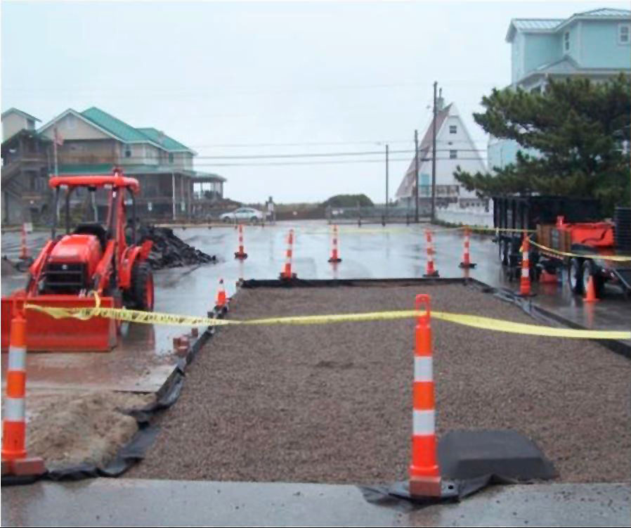 Impervious pavement is being replaced with pervious pavement around south storm drain, Hanover Seaside Club is in left background. Photo: Grogan, Mallin study