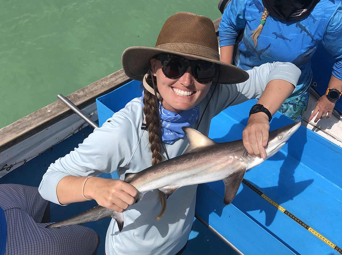 Savannah Ryburn holds a juvenile blacktip shark during her fieldwork in the Galapagos. Photo: Contributed