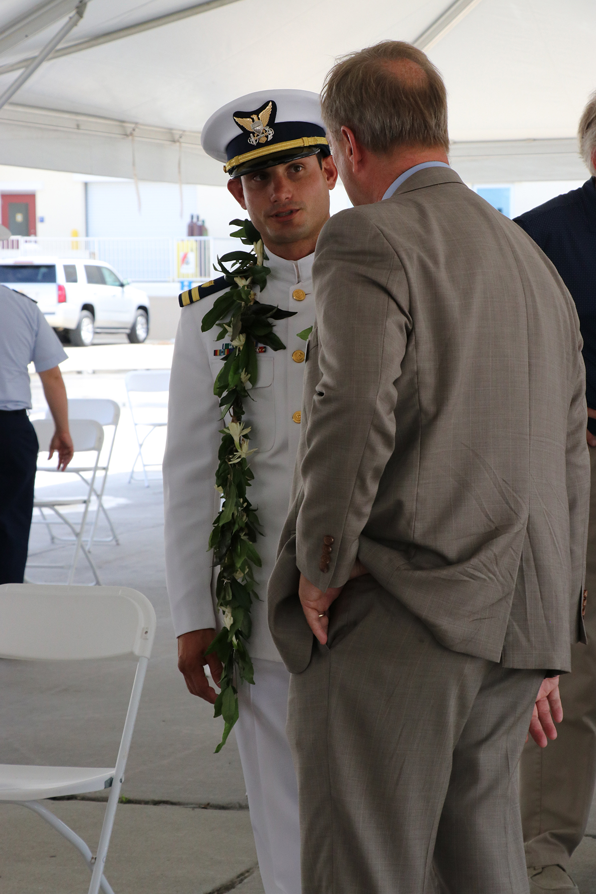 USCG Lt. Reginald Reynolds, captain of the cutter Glen Harris, speaks with Bob Montgomery, trustee of the Coast Guard Foundation and Commissioning Committee chair, at the commissioning. Photo: Ann Cary Simpson