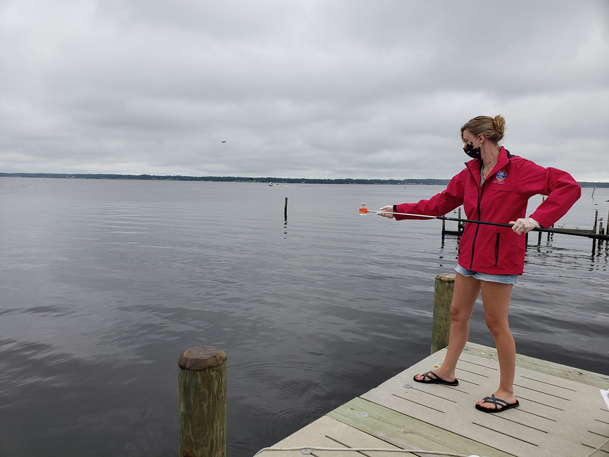  Lower Neuse Riverkeeper Katy Hunt collects water samples earlier this month to test for E. coli at Broad Creek off the Neuse River near a wastewater treatment plant. Photo: Sound Rivers