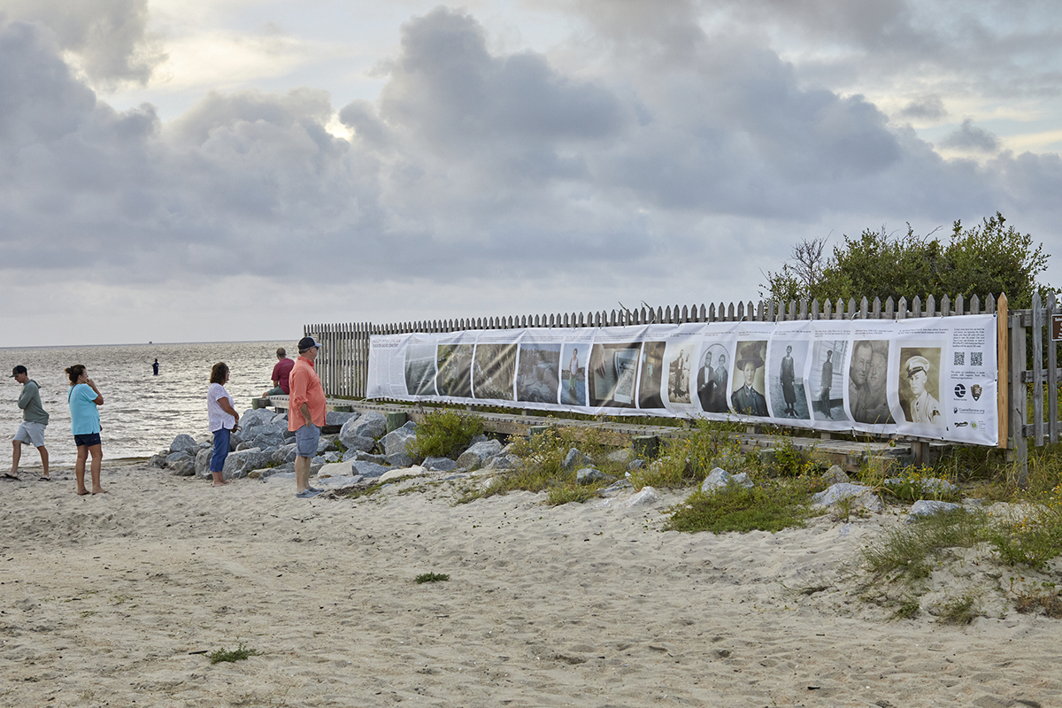 Visitors view the Photoville FENCE Exhibit for Tide and Time at the Salvo Day Use Area on Hatteras Island. Photo: Justin Cook