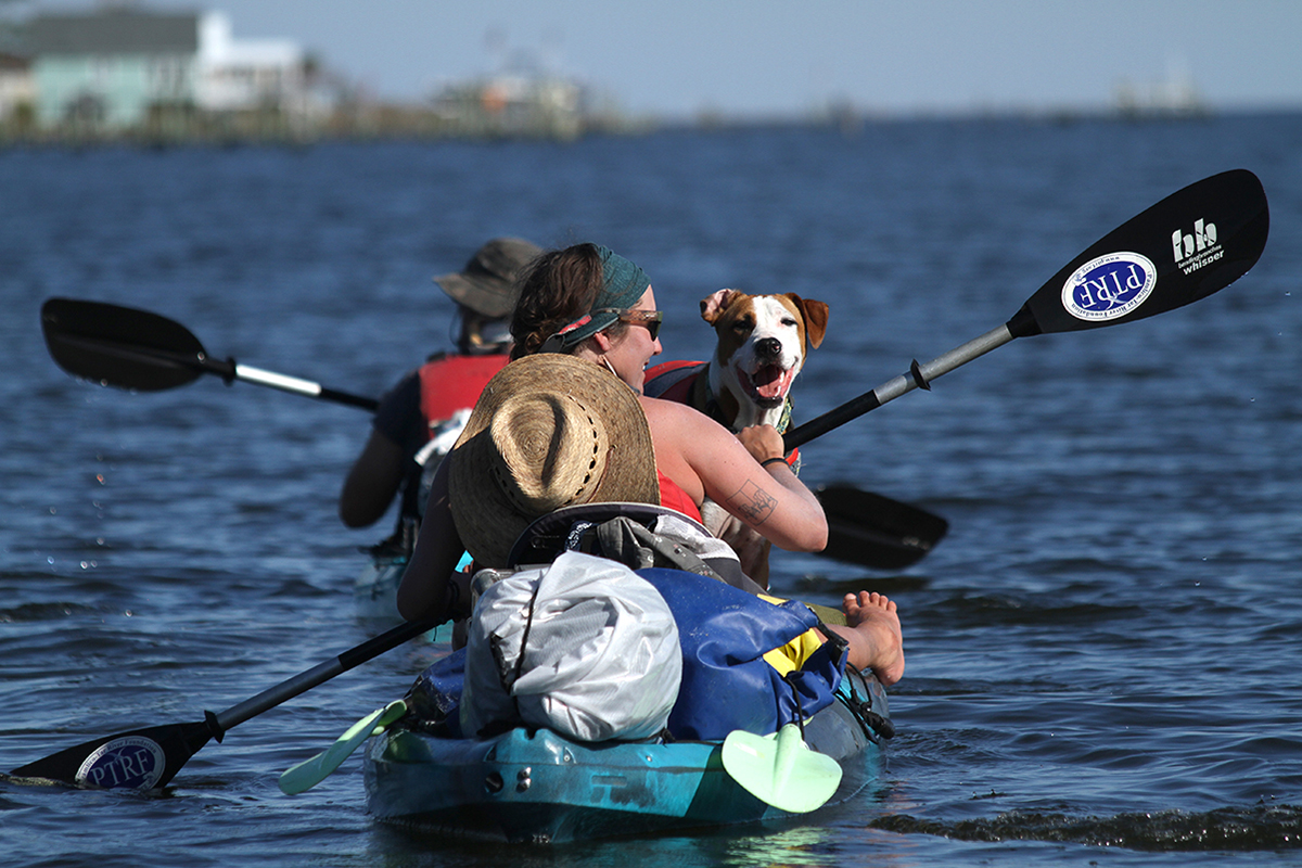 Paddlers Clay Barber, left, Sound Rivers' environmental projects coordinator, Pamlico-Tar Riverkeeper Jill Howell and Miller the pup head out on the fourth day of their five-day journey down the Pamlico River. Photo: Sound Rivers