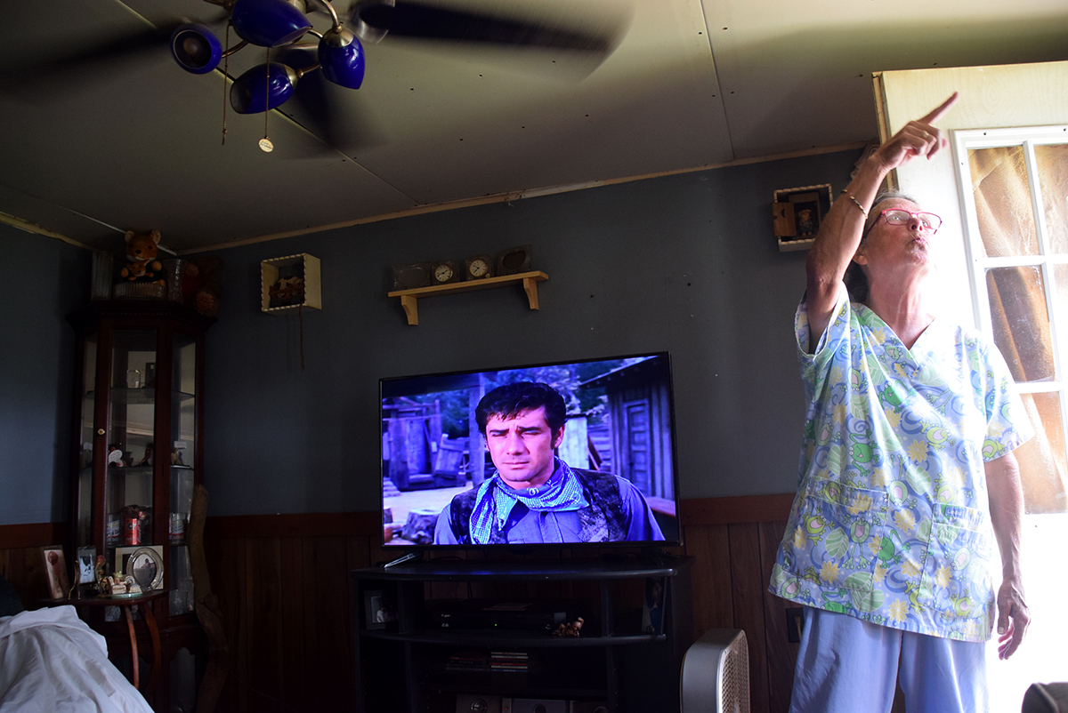 Brenda Hite of Carteret County points out damage to her mobile home, some partially repaired, that resulted from Hurricane Florence in 2018. Photo: Mark Hibbs