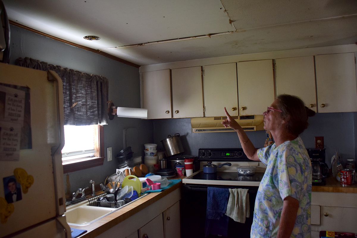 Brenda Hite points to partial repairs to her ceiling that were approved as completed by the state agency NC STEP. Photo: Mark Hibbs