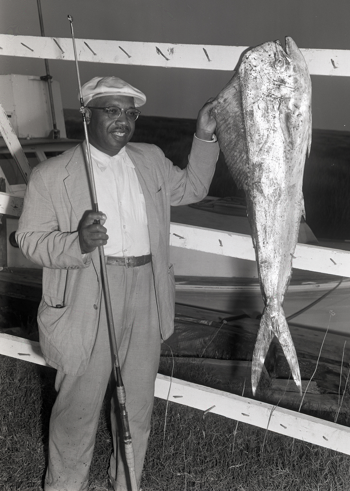 Capt, Joe Berry poses with his dolphin catch at Dykes Creek in this 1956 image from the Aycock Brown Papers. Photo: Courtesy of the Outer Banks History Center, State Archives of North Carolina 