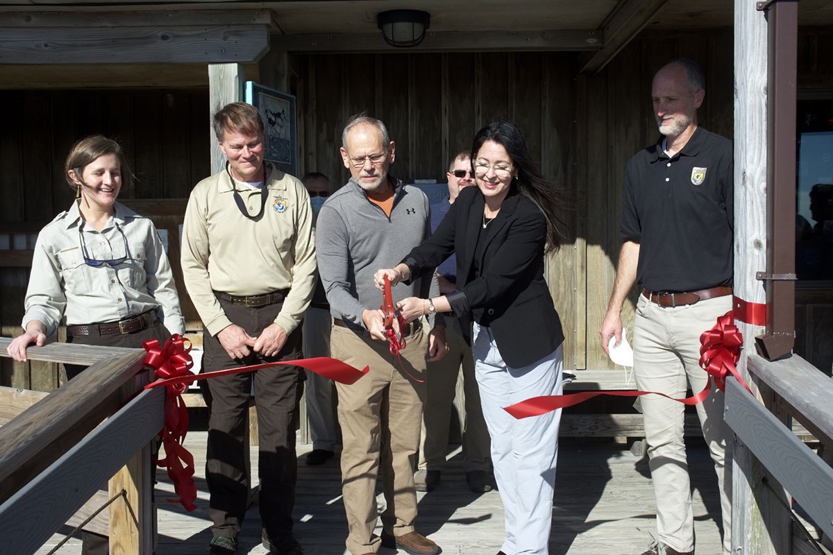 Officials hold a ceremonial ribbon cutting Friday for the renovated and raised Pea Island Visitor Center. Participating are, from left, Coastal N.C. Refuges Complex Project Leader Rebekah Martin, Pea Island and Alligator National Wildlife Refuge Manager Scott Lanier, Pea Island and Alligator National Wildlife Refuge Manager; retired refuge manager Mike Bryant, Interior Department Assistant Secretary for Fish and Wildlife and Parks Shannon Estenoz and U.S. Fish and Wildlife Deputy Regional Director Mike Oetker.