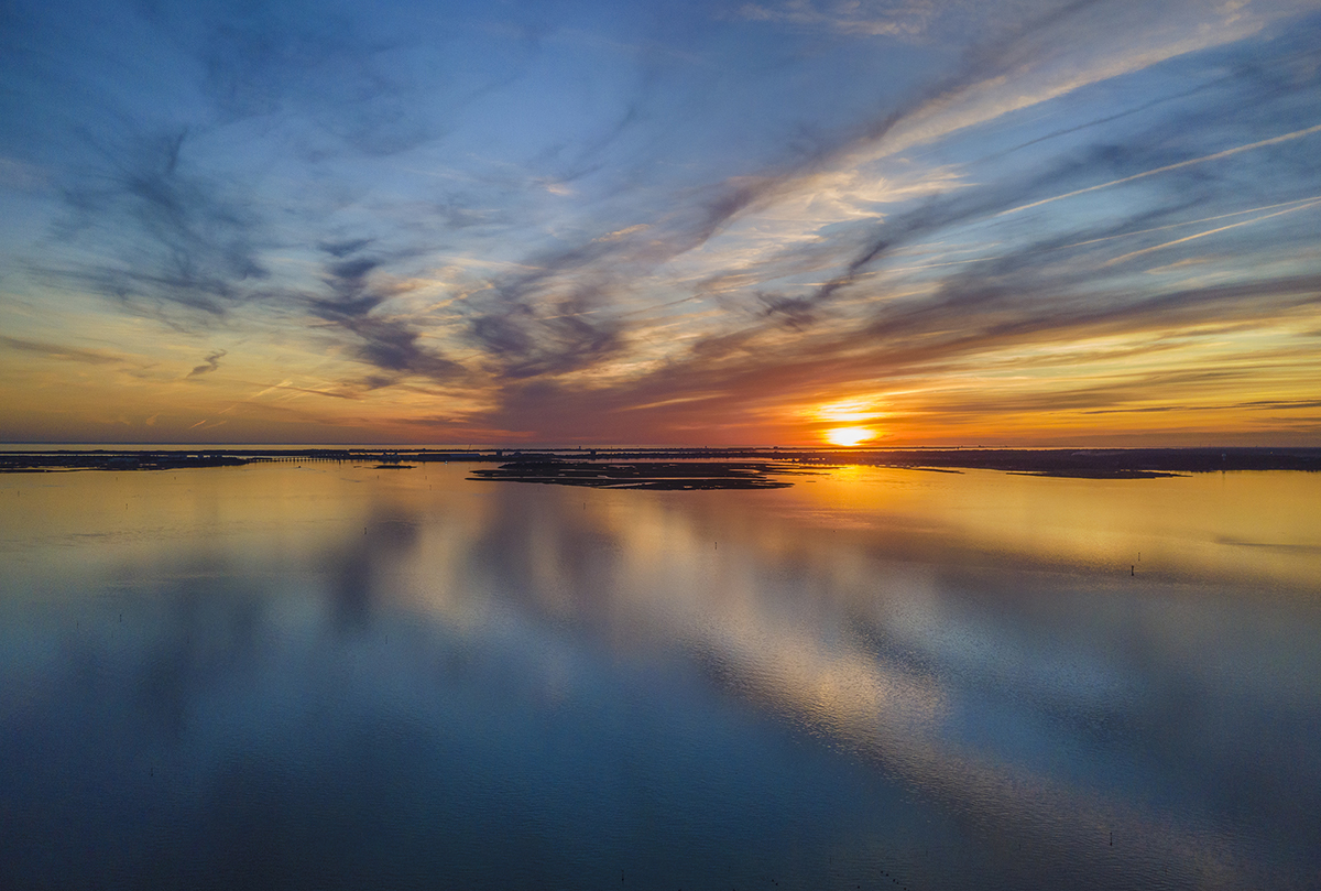The sun sets over the Newport RIver in Carteret County on a calm December evening. Photo: Dylan Ray