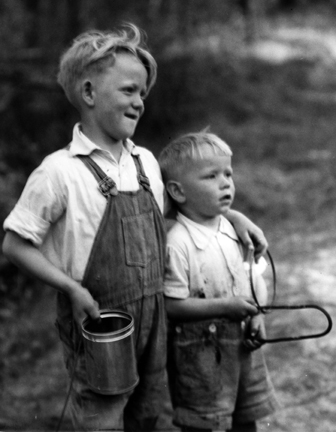 Brothers James Lewis Beasley Jr. and Ralph Beasley at play on Little Colington Island, 1938. They are playing a game the village children called “hoop and wire,” using an old coat hanger and a round gill net weight. Both boys grew up and became commercial fishermen. Photo: Charles A. Farrell, courtesy, State Archives of North Carolina 