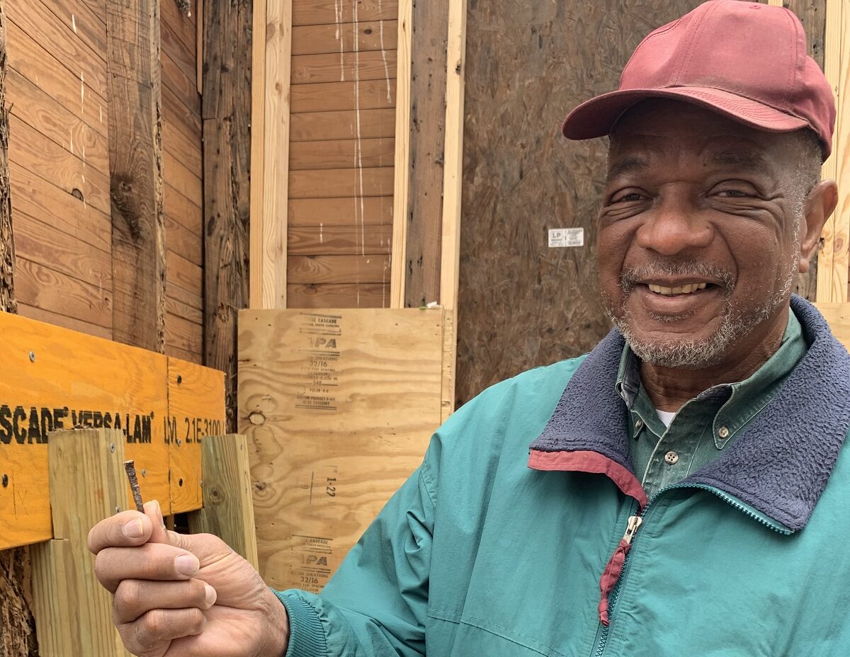 Al Beatty, president of the Cedar Hill/West Bank Heritage Foundation, holds an old nail pulled from a rotted area of wood framing Reaves Chapel. The chapel was built in the mid-1800s by former enslaved people on the Cedar Hill Plantation and other nearby plantations.