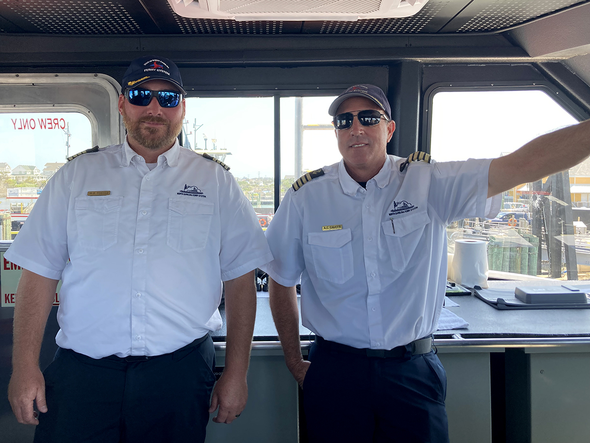 Ferry captains Marshall Foster, left, and Anthony Gavetti pose in the pilot house. Photo: Catherine Kozak