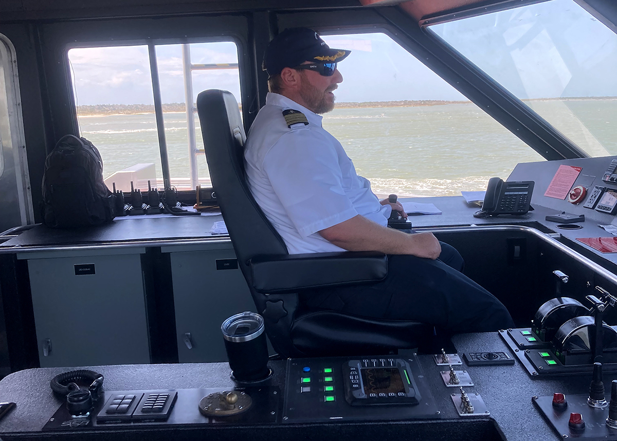 The N.C. Department of Transportation passenger ferry Ocracoke Express gets underway Monday with Capt. Marshall Foster at the helm. Scheduled runs for the new ferry began Tuesday. Photo: Catherine Kozak