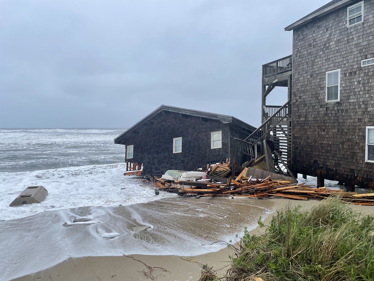 Debris from the collapsed house at 24235 Ocean Drive in Rodanthe washes in the surf Tuesday. Photo: National Park Service