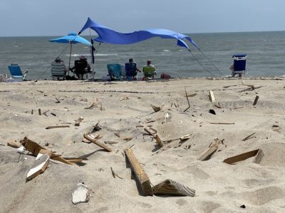 Debris is strewn on the beach Monday south of the sites of two fallen houses. Photo: NPS 