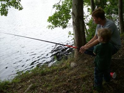 A young boy and his dad during a past Kids Fishing Day at the Croatan National Forest. Photo: US Forest Service