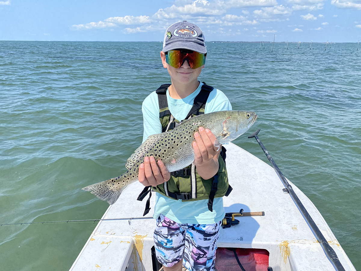 Emerson Ellis of Sneads Ferry shows off a big topwater trout. Photo Capt. Gordon Churchill