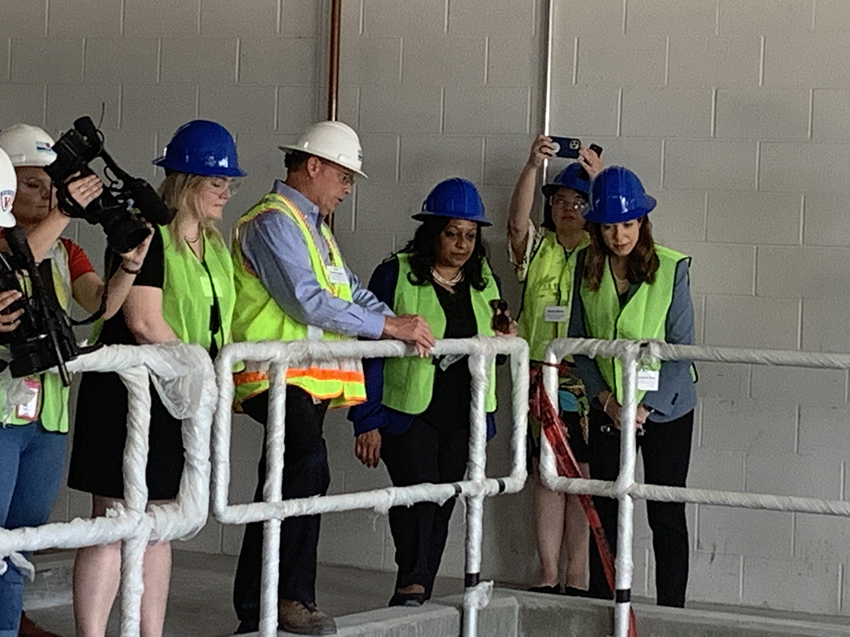 EPA Assistant Administrator for Office of Water Radhika Fox and N.C. Department of Environmental Quality Secretary Elizabeth Biser, right, look down into a cement compartment inside the new addition to the Cape Fear Public Utility Authority’s Sweeney Water Treatment Plant in downtown Wilmington. Photo: Trista Talton