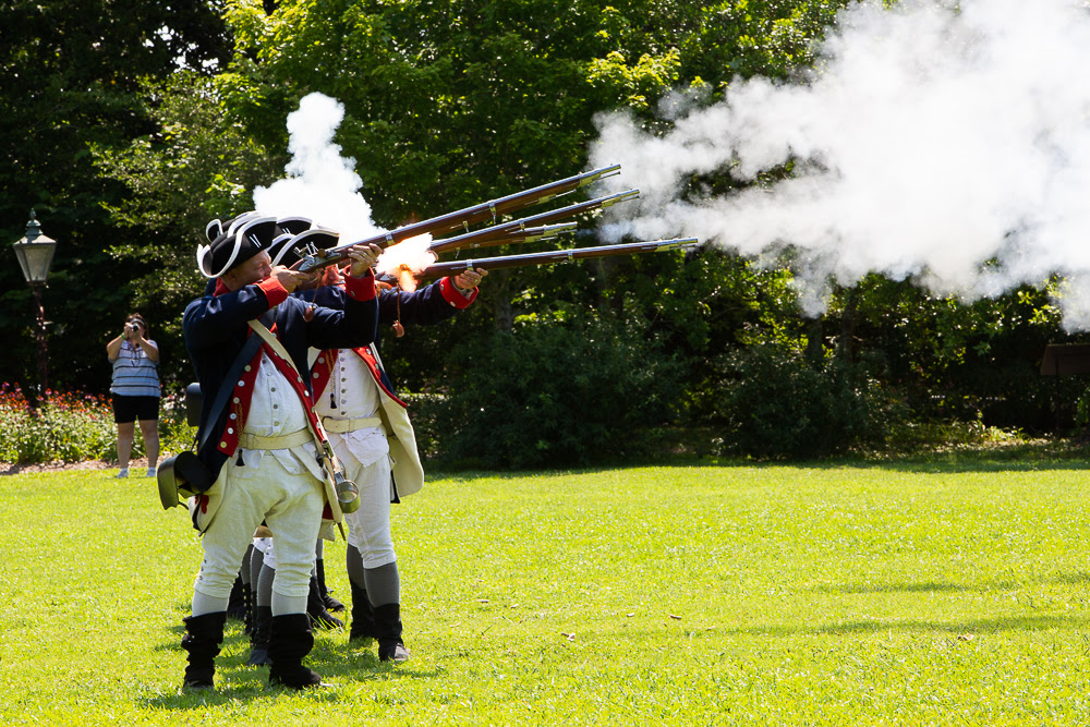 The 1st North Carolina Regiment fire muskets during a past Glorious Fourth event at Tryon Palace in New Bern. Photo: NCDNCR