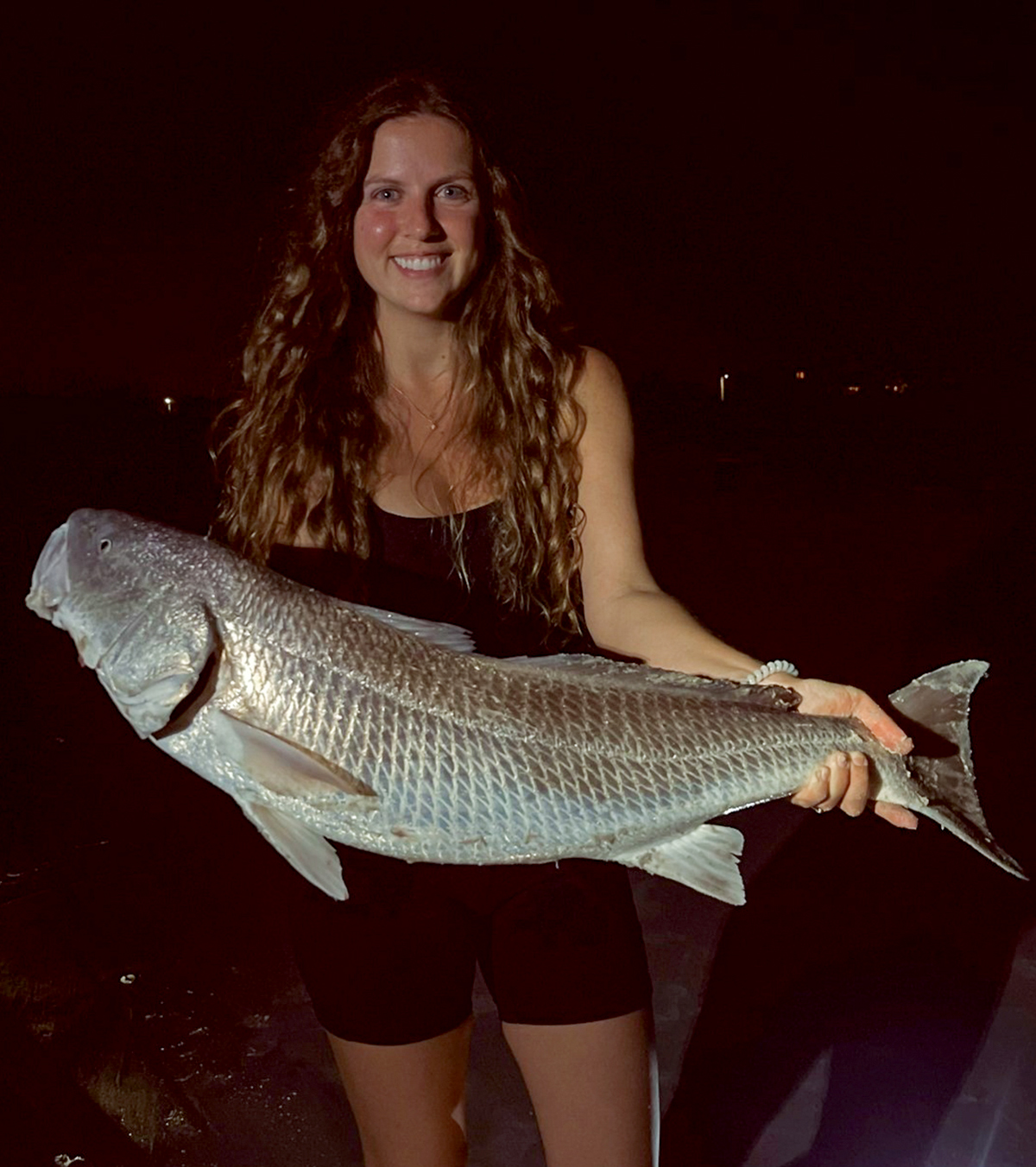 Rachel Hermann of Wilmington caught her tagged red drum while fishing at Wrightsville Beach and was selected to receive an additional $100 in the yearly drawing. Photo: Division of Marine Fisheries