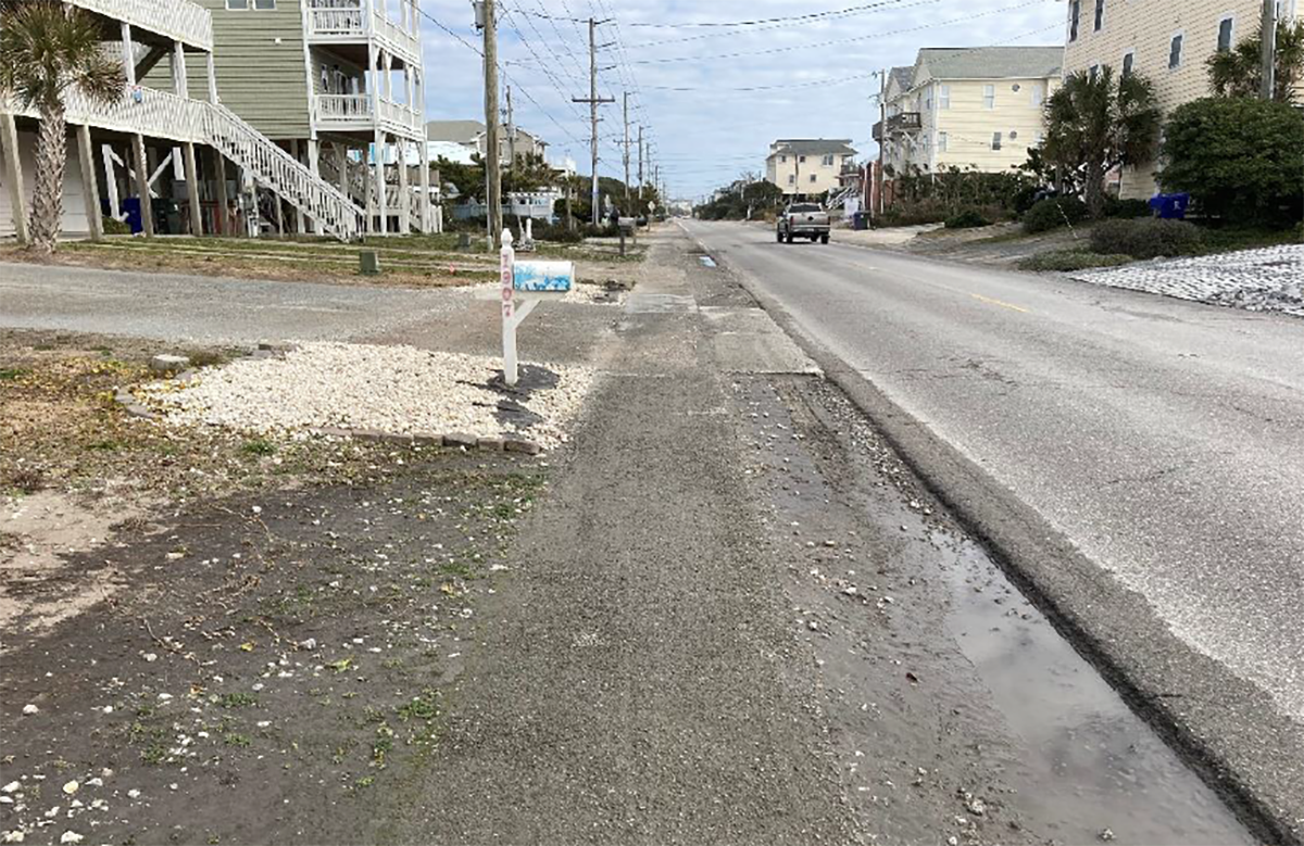 This view looking northeast from 1907 S. Shore Drive shows discolored soil where stormwater had ponded. Photo from the feasibility study.