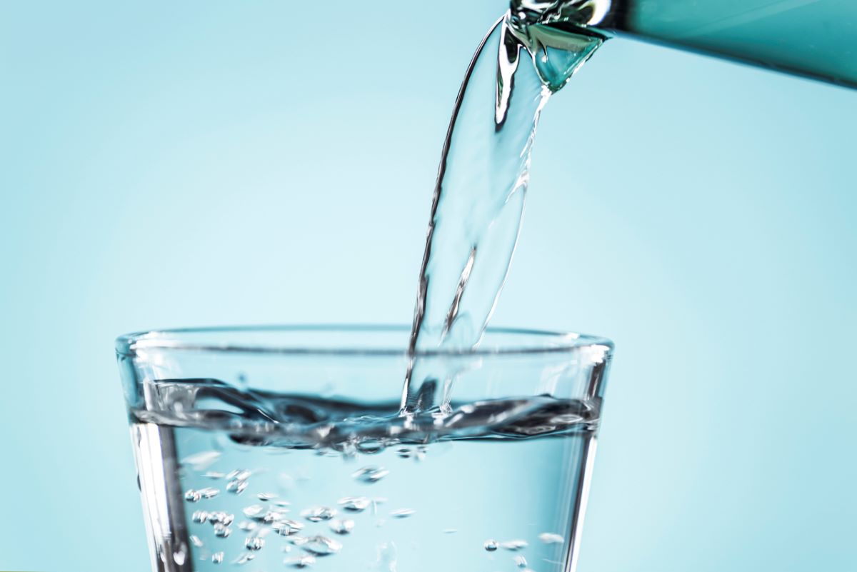 Water from a faucet fills a glass. Photo: Public domain